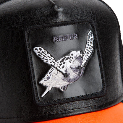 Close-up of The Farm's Shell Smoke hat: black with an embroidered sea turtle patch, "REEFER" above it, and an orange brim. All sales final.