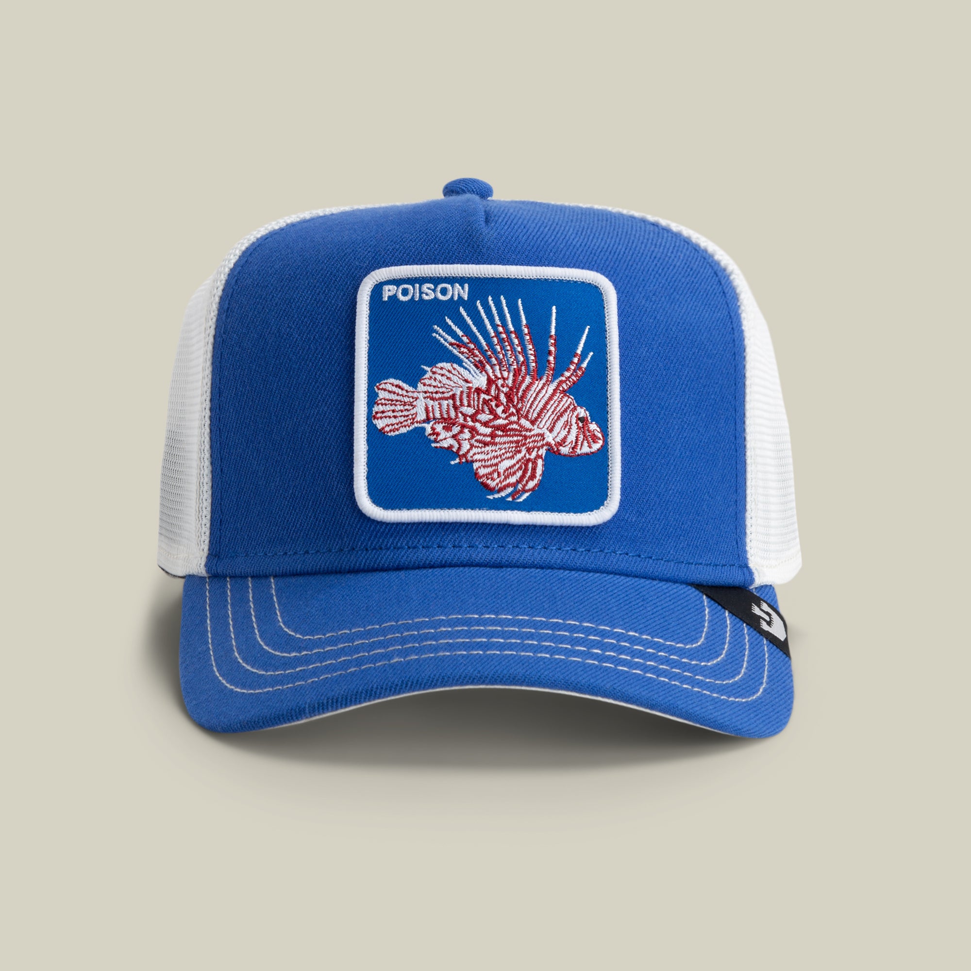 The Farm's Lionfish Heat is a blue and white trucker hat featuring a patch of a red lionfish with "POISON" embroidered above it. All sales are final.