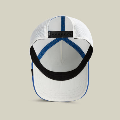 The Farm Lionfish Heat cap in white and blue, shown from above to display the inside, black sweatband, mesh back panels, and adjustable strap. All Sales Final.