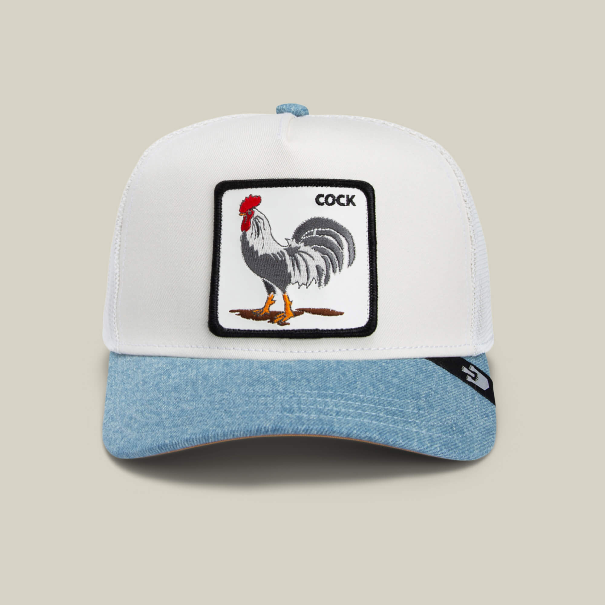 The Goorin Bros. Rooster Fan Institution Ball Club cap features a white and light blue design with an illustrated rooster and "COCK" in the corner—perfect for adding a playful, game-day touch to any outfit.