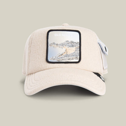 The Goorin Bros. AllmiMator TOAST cap features a patch with an embroidered crocodile and "OLD SCHOOL" text on the front, channeling vintage sweater style.