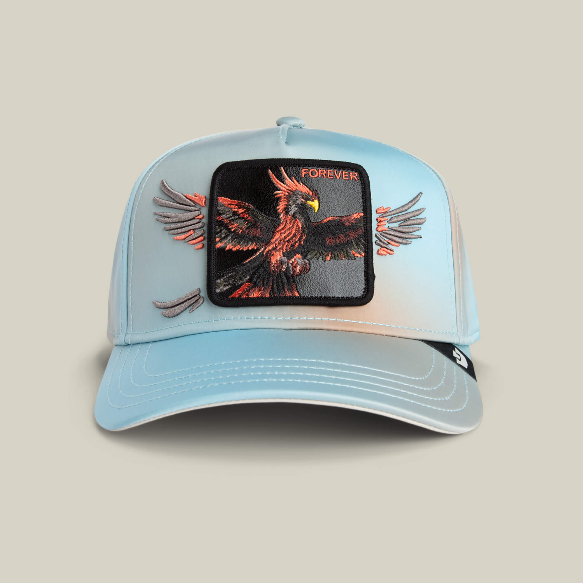 The Goorin Bros. Never Stop Never Stopping sky-blue baseball cap features a red and black eagle patch in flight with "FOREVER" embroidered above it, offering a timeless style.