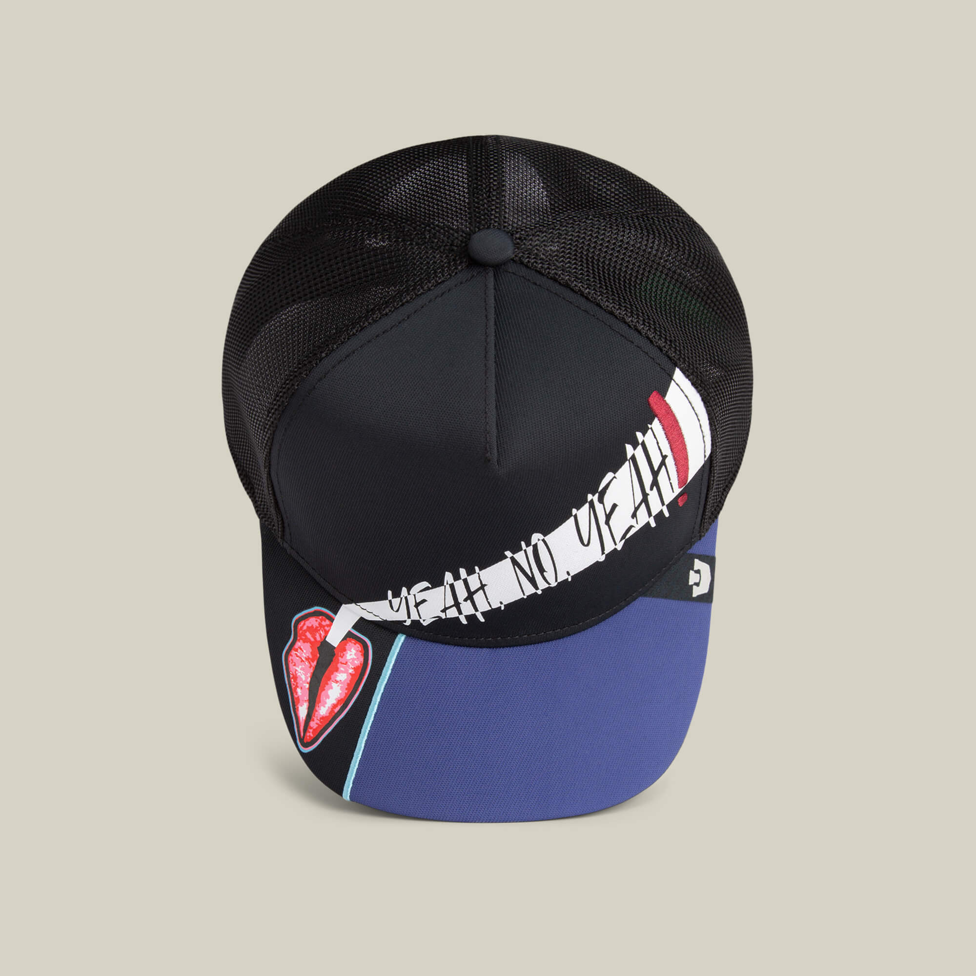 The Means Yes hat by Goorin Bros. is a black mesh trucker cap with a blue brim, bold red lips graphic, and stylized white, black, and red text—a standout accessory for making bold style statements.