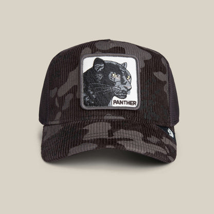 The Goorin Bros. Panther Camo cap is a black and dark brown corduroy hat with stealth camo, featuring a rectangular patch embroidered with a black panther and the word "PANTHER" on the front.