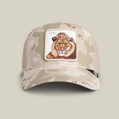The King Camo baseball cap by Goorin Bros. features tan desert camo, a front patch embroidered with a lion's face and the word KING—ideal for fans of bold camo style.