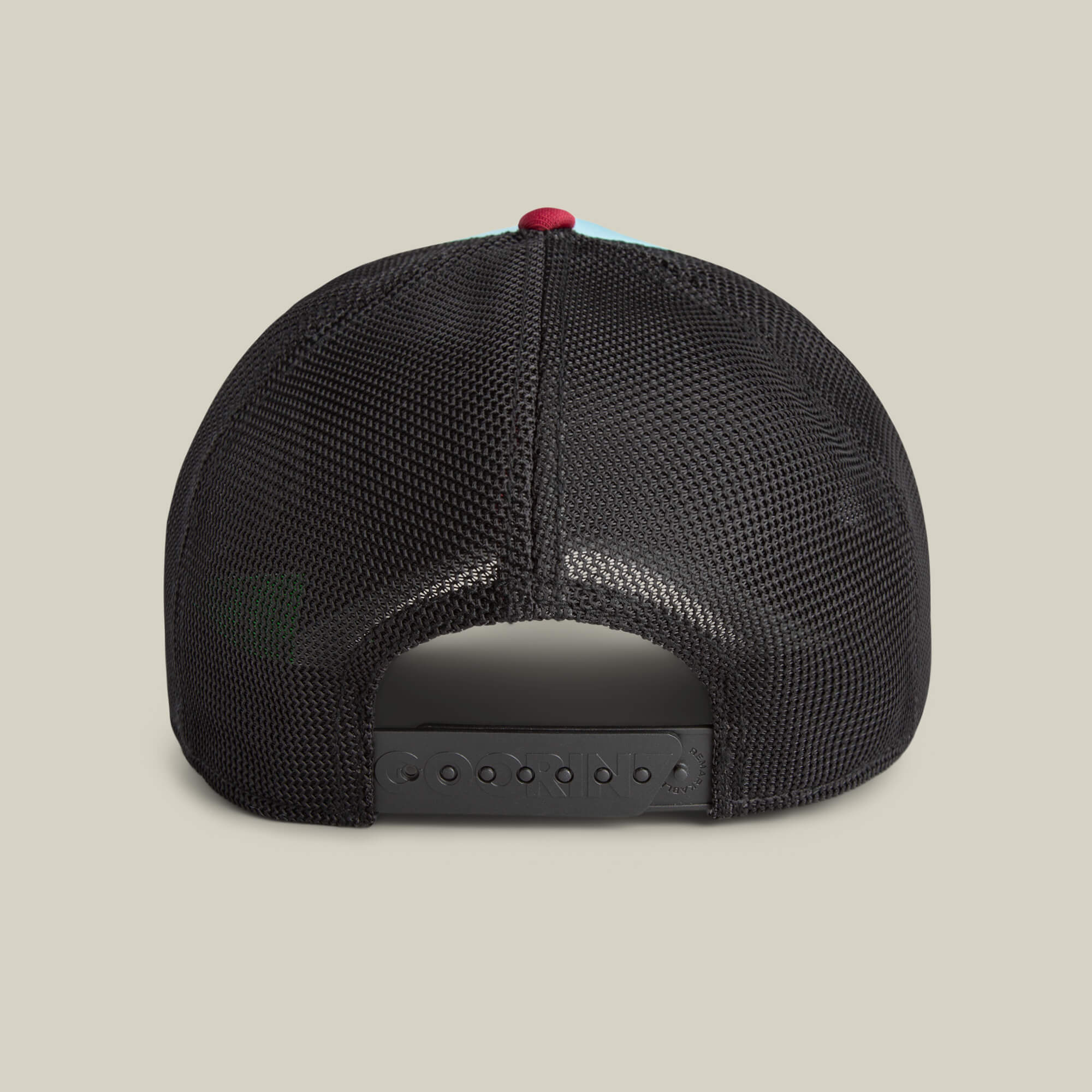 Back view of the Goorin Means Understood black mesh trucker hat with adjustable snapback strap and sturdy brim, shown against a plain light background.