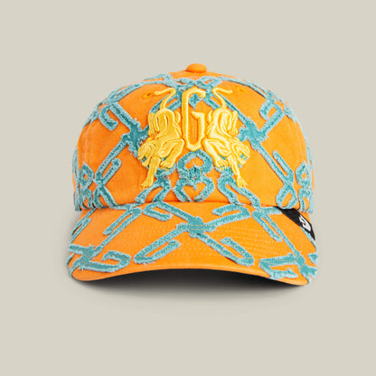 The Goorin Bros. "Future Baby Daddy" cap features an orange base, blue embroidered interlocking patterns all over, and a yellow lion crest on the front—ideal for making a bold statement.