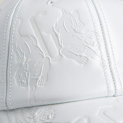 Close-up of the white leather front panel of Goorin Bros.' classic-fit "Put a Panther On It" hat, featuring embossed panther and geometric designs.
