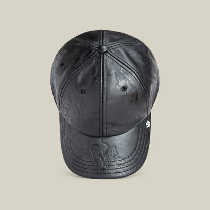 The Put a Panther On It cap by Goorin Bros. is a black leather baseball cap with subtle embossed patterns and a classic fit, shown from the front on a plain beige background.