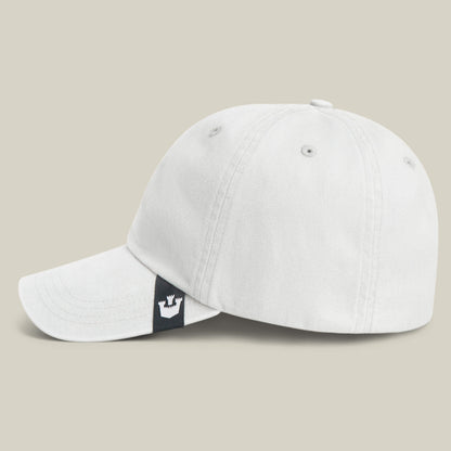 The Goorin Bros. Papa Cap Italiano is a classic white baseball cap with a curved brim, inspired by vintage style and finished with a small black tag featuring a white crown logo on the adjustable back strap.