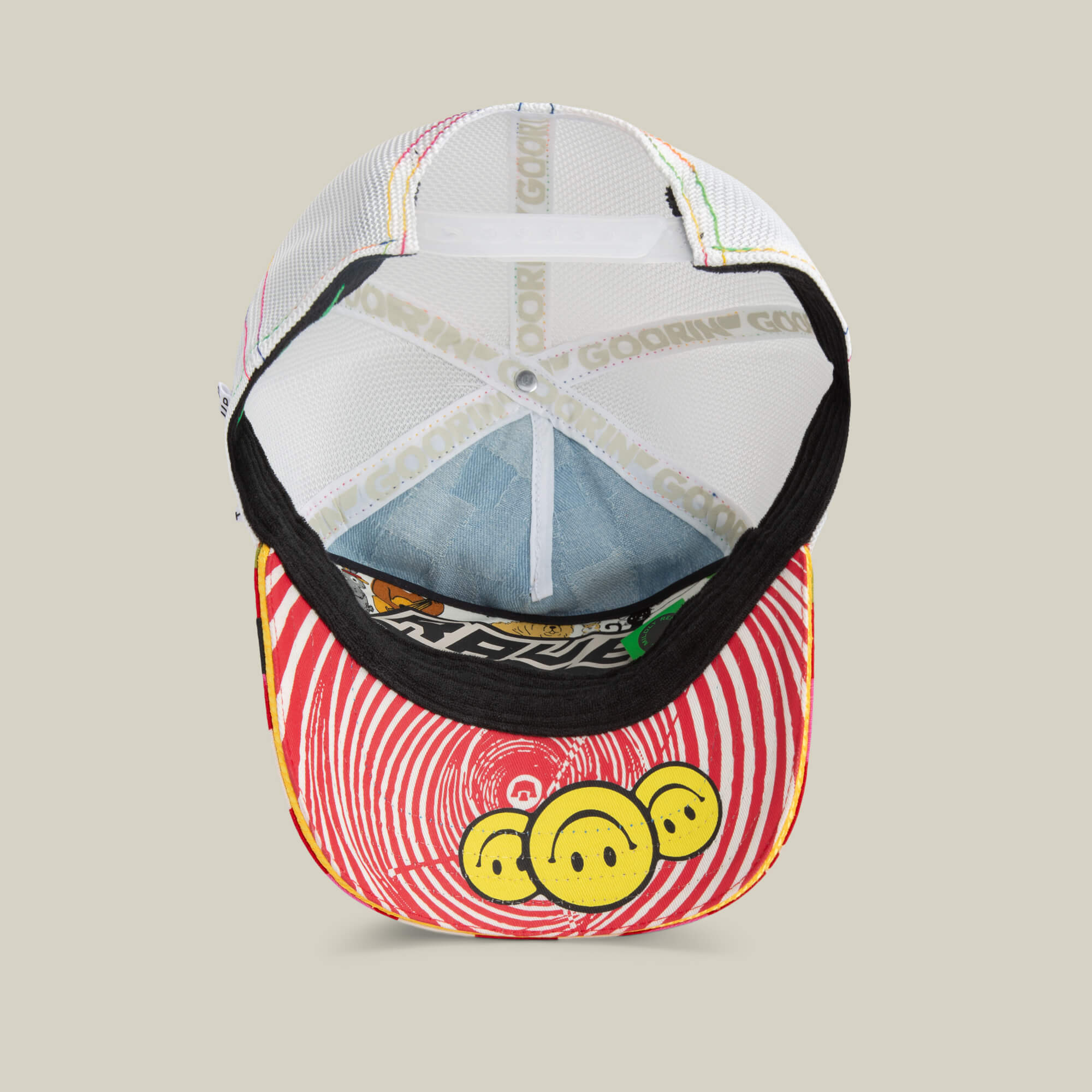 The Goorin Bros. Drum and Bass festival hat features a red and white spiral design with three yellow smiley faces on the brim, plus visible mesh and tag details underneath.