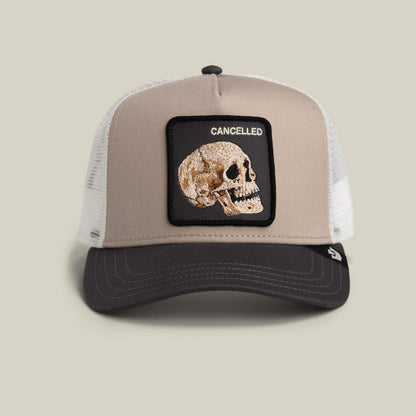 The Cancelled Skull by Goorin Bros. is a multi-color trucker hat with a stitched skull patch reading CANCELLED above it.