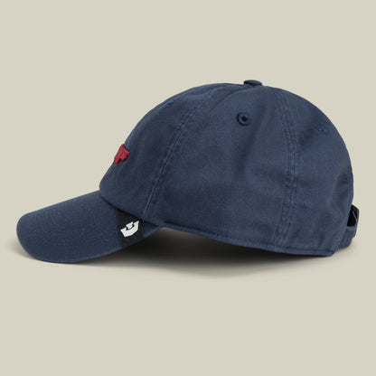 The Goorin Bros. Papa Core is a navy blue corduroy dad hat with an embroidered red logo on the front and a small white patch detail on the side, displayed against a neutral beige background.