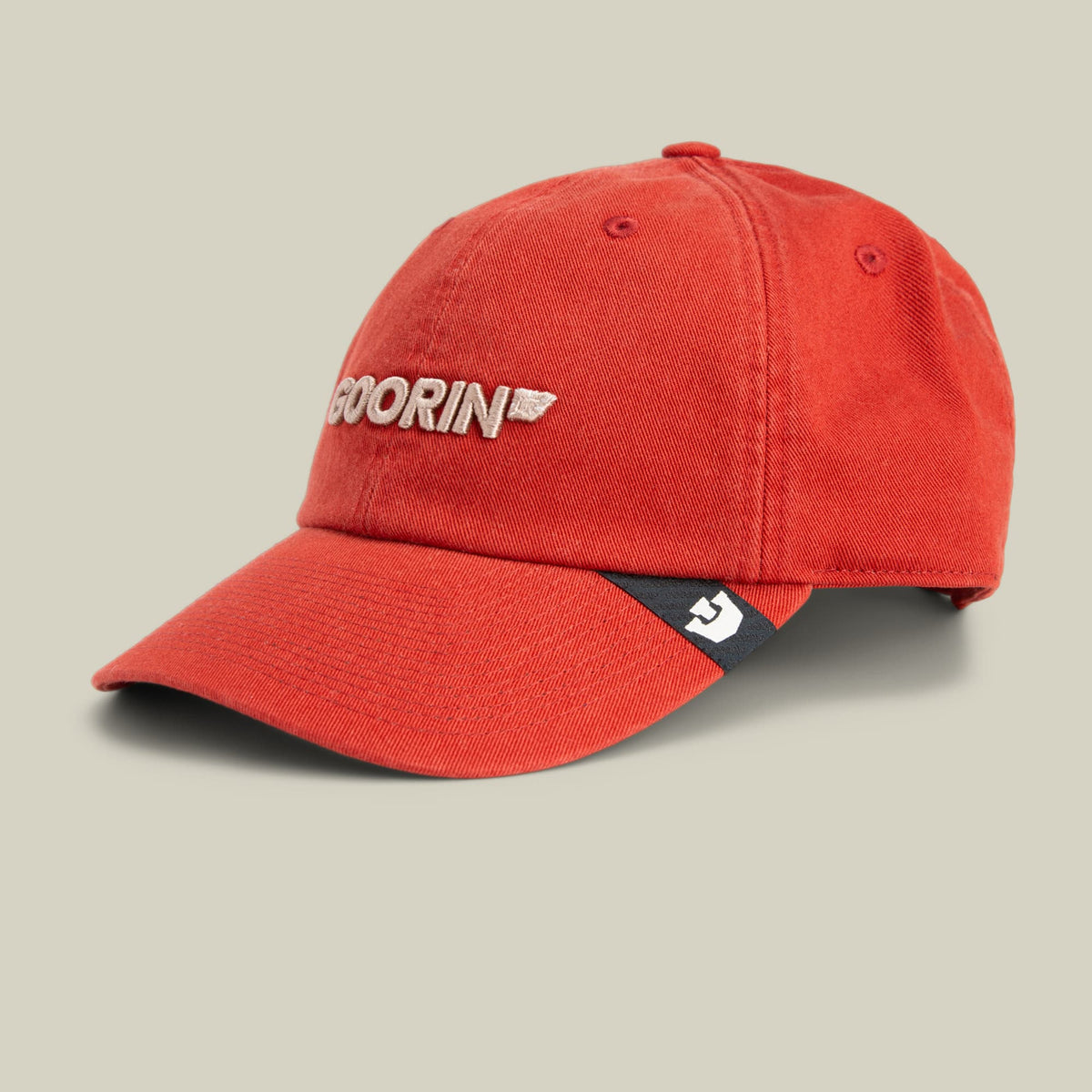 The Goorin Bros. Papa Core is a red baseball cap with embroidered white logo text on the front and a small patch on the side, displayed against a neutral beige background.