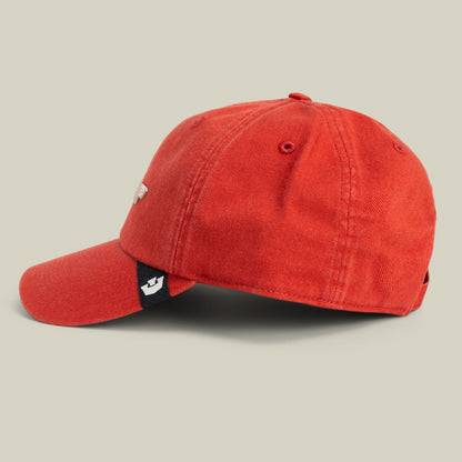 The Goorin Bros. Papa Core red corduroy baseball cap shown in side view against a neutral beige background, featuring a small embroidered patch detail on the side and black underbill.