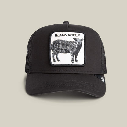 The Black Sheep by Goorin Bros. is a black trucker hat with a mesh back and a front patch of a black sheep and "BLACK SHEEP" text—ideal for those who like to stand out.