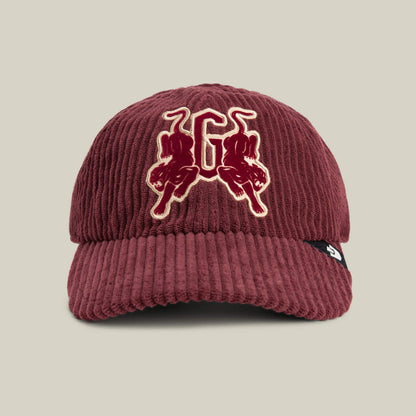 A burgundy Goorin Bros. Bleacher Report cap featuring a corduroy crown, embroidered letter G with two bulls on the front, and a black side tag with a white logo.