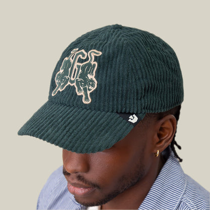 Someone wearing a Goorin Bros. Bleacher Report cap with a corduroy crown and embroidered G, paired with a blue and white striped shirt.