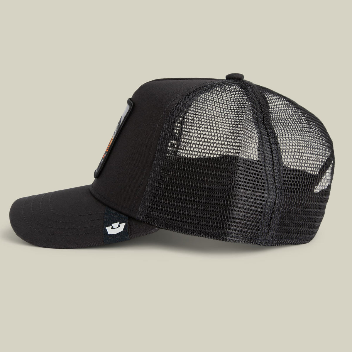 The Goorin Bros. Mamba Trucker is a black mesh snapback cap with a structured front panel and adjustable back, featuring the brand's small logo patch on the side, shown in a studio product shot against a neutral background.