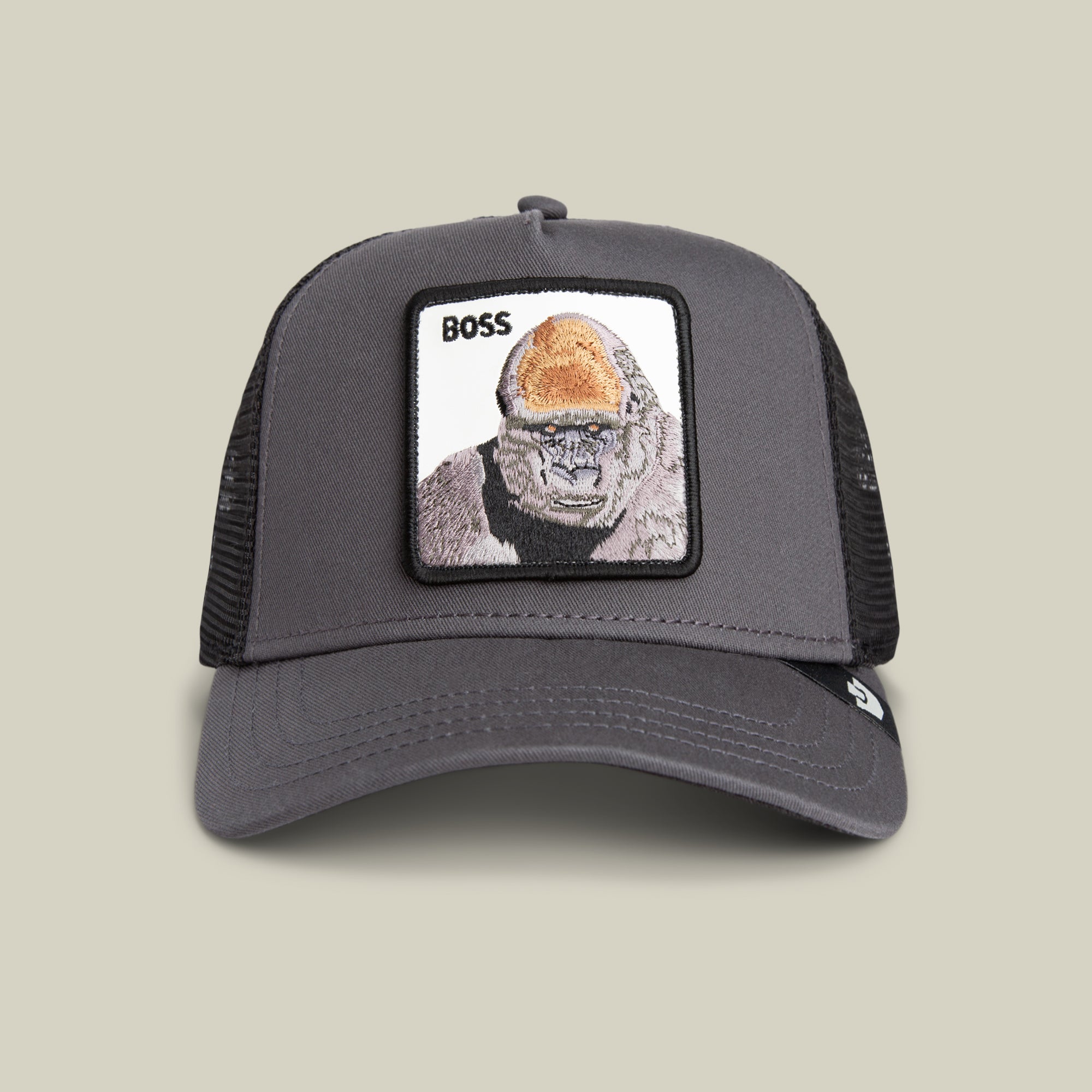 The Boss Trucker by Goorin Bros. is a gray mesh trucker hat featuring a bold gorilla patch with the word "BOSS"—a standout accessory for power moves and unique style.