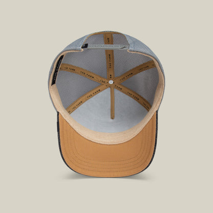 A top-down view of the inside of The Mamba cap by Goorin Bros., featuring tan and black mesh lining, detailed stitching, and an interior band labeled THE LAND—a bold hat crafted for those with a predator mindset.