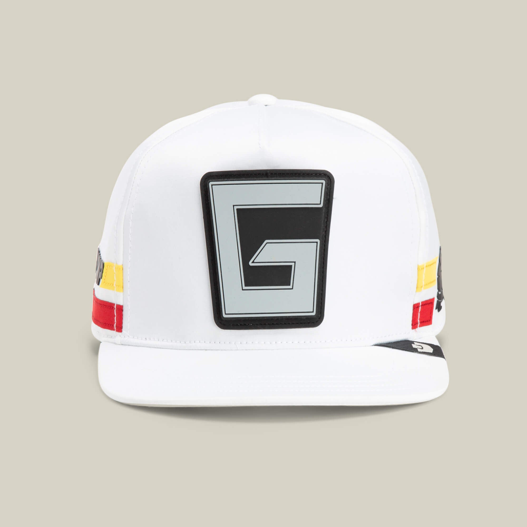 The Goorin Bros. Pole Position - Speedbump hat in DUST features a bold black and gray G patch on the front plus striking red, yellow, and black side stripes for standout style.
