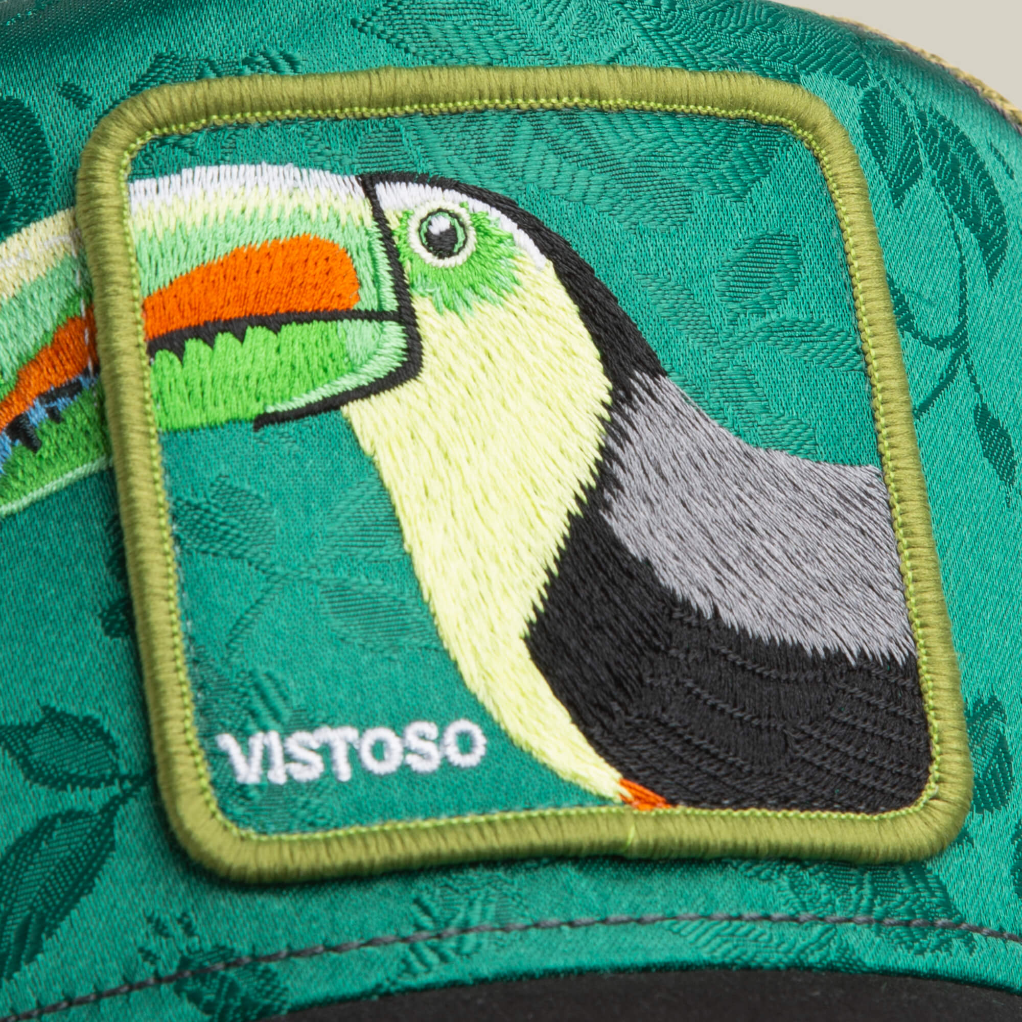 The Goorin Bros. Belize Toucan is a green trucker hat with a stitched patch featuring an embroidered toucan and "VISTOSO" in white text.