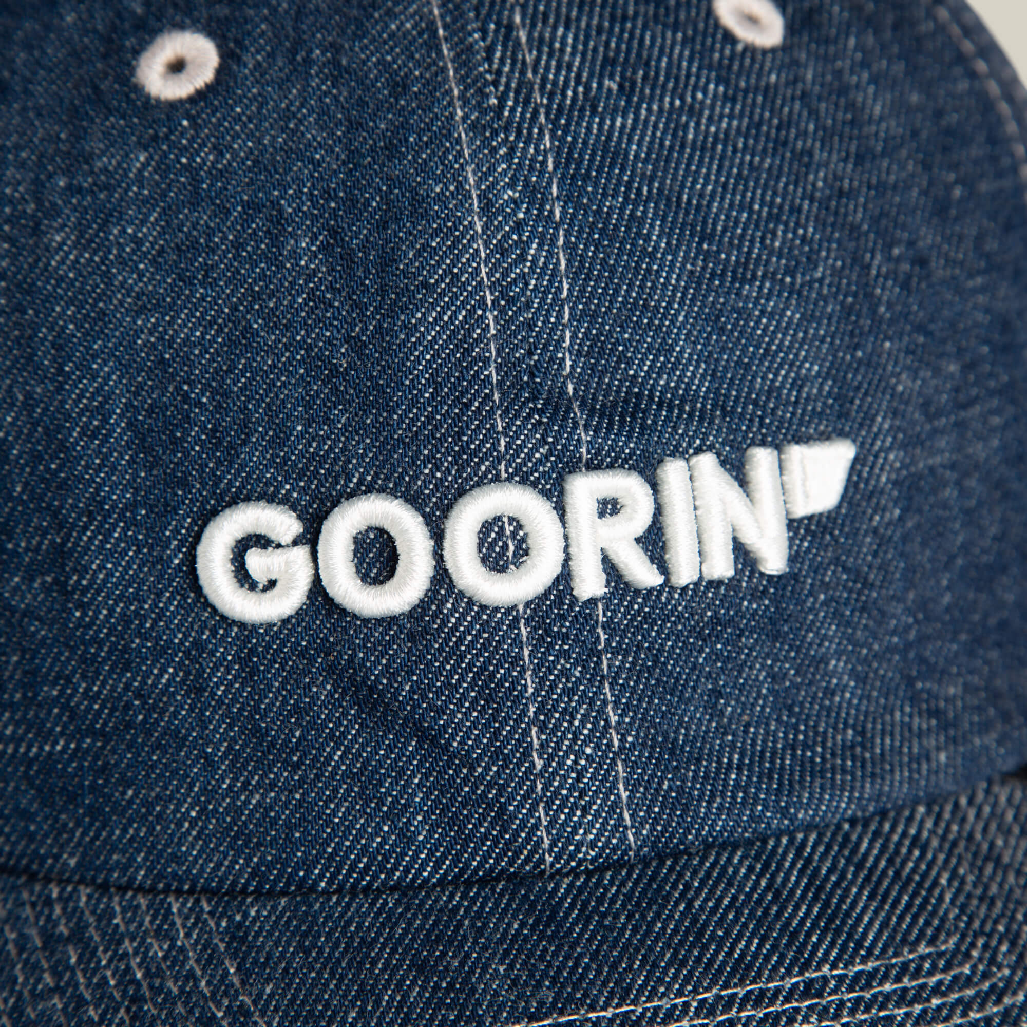 Close-up of the Papa Core Denim hat by Goorin Bros., a blue denim low-profile cap with the GOORIN wordmark embroidered in white on the front.