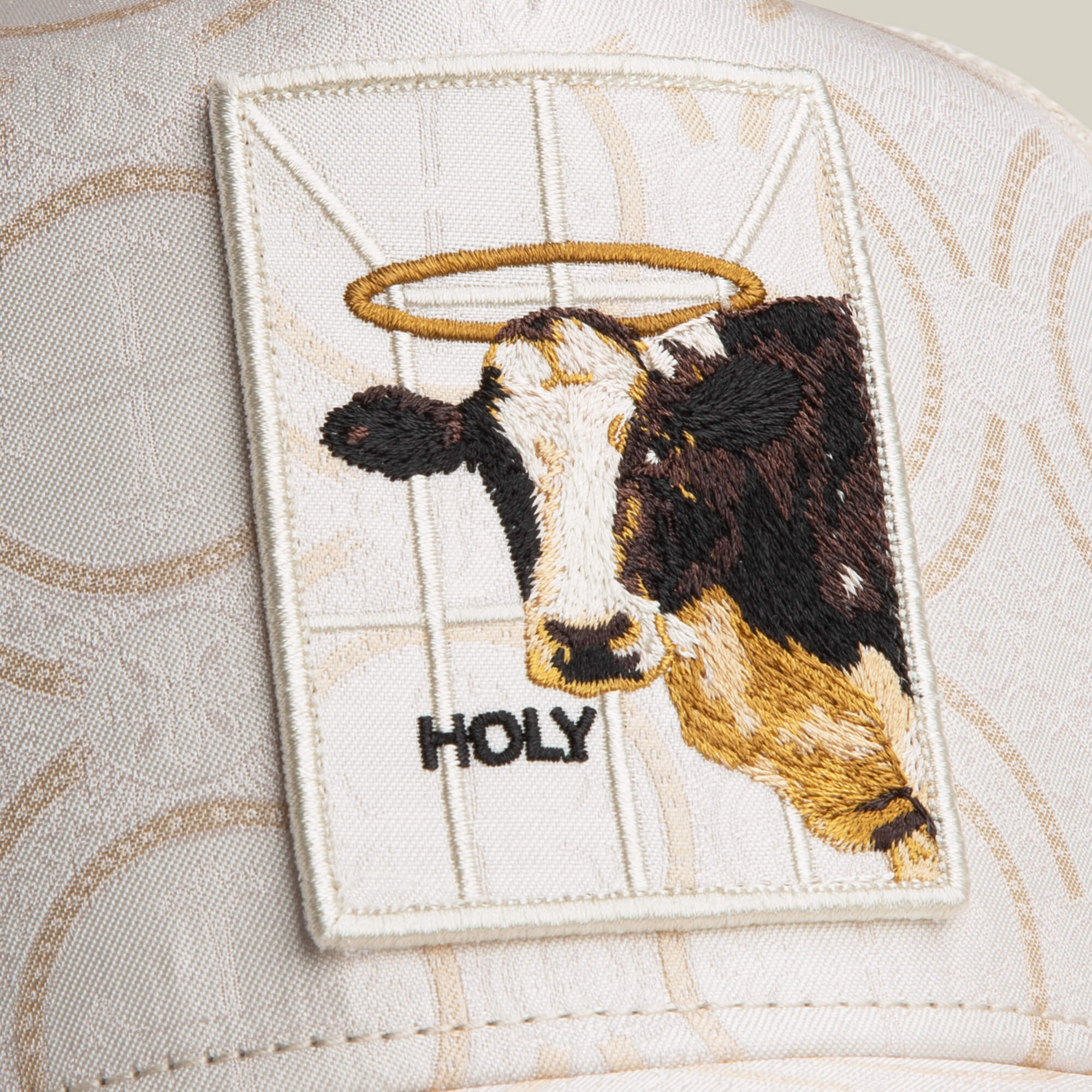 Add playful faith to your style with Goorin Bros.' Religulous - Holy Cow patch, featuring a haloed cow and "HOLY" text on subtly patterned fabric—perfect for hats or accessories.