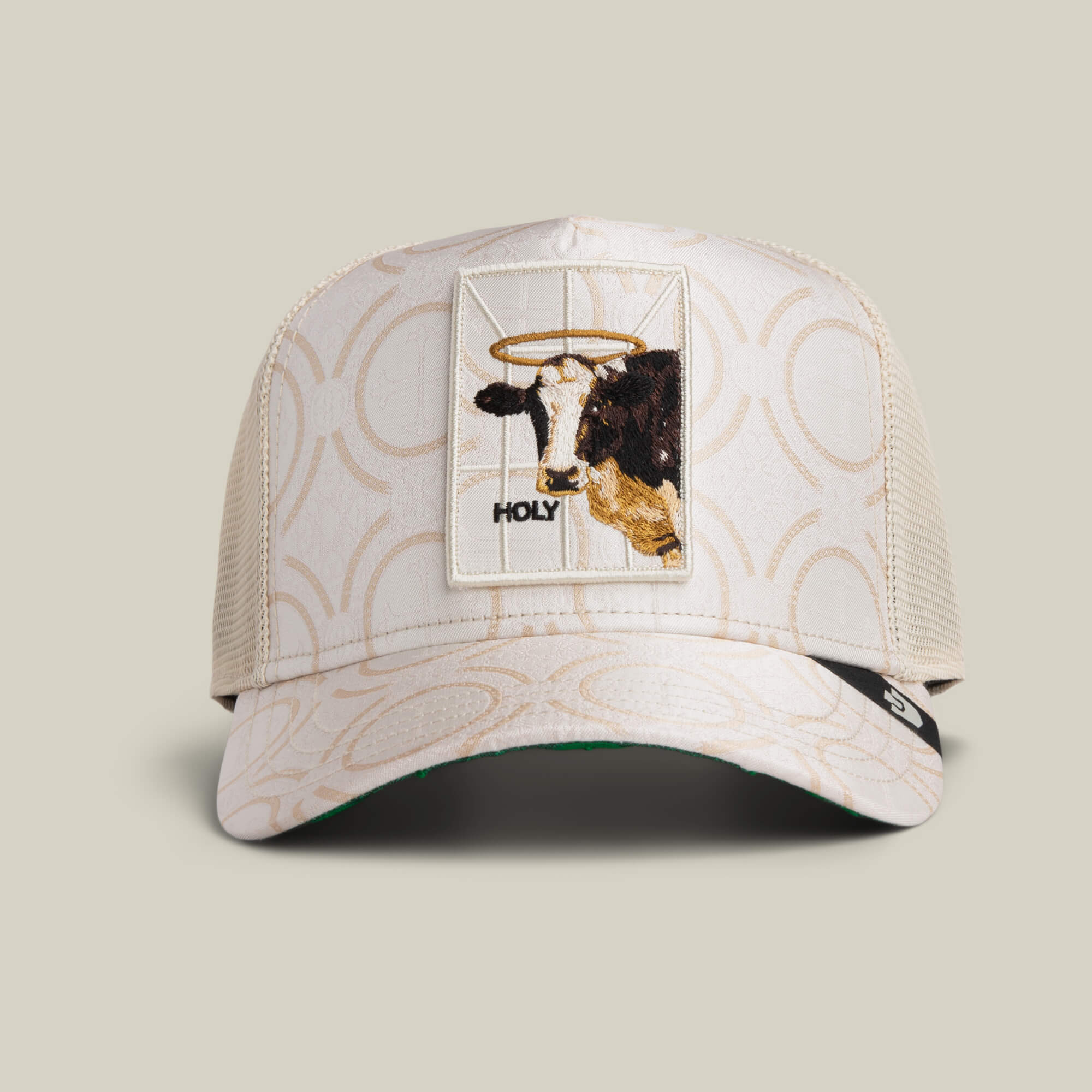 The Goorin Bros. "Religulous - Holy Cow" trucker hat in CHALK features a mesh back and a patch of a haloed sacred cow above the word HOLY—a lighthearted accessory for those who blend faith and humor.