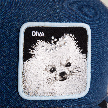Close-up of Goorin Bros. Diva Dawg cap in blue denim, showcasing a fluffy dog patch with rhinestone accents and "DIVA" on the top left—a chic accessory for dog lovers.
