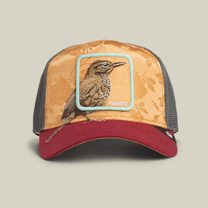 The Goorin Bros. Costa Rica Thrush trucker hat features a gold floral front, maroon brim, charcoal mesh sides, and a FUERTE-labeled patch on the front.