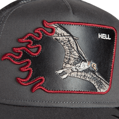 Close-up of the Goorin Bros. "Hell Flames" black trucker hat, featuring an embroidered bat patch, red flames, and the word HELL in the upper right corner.