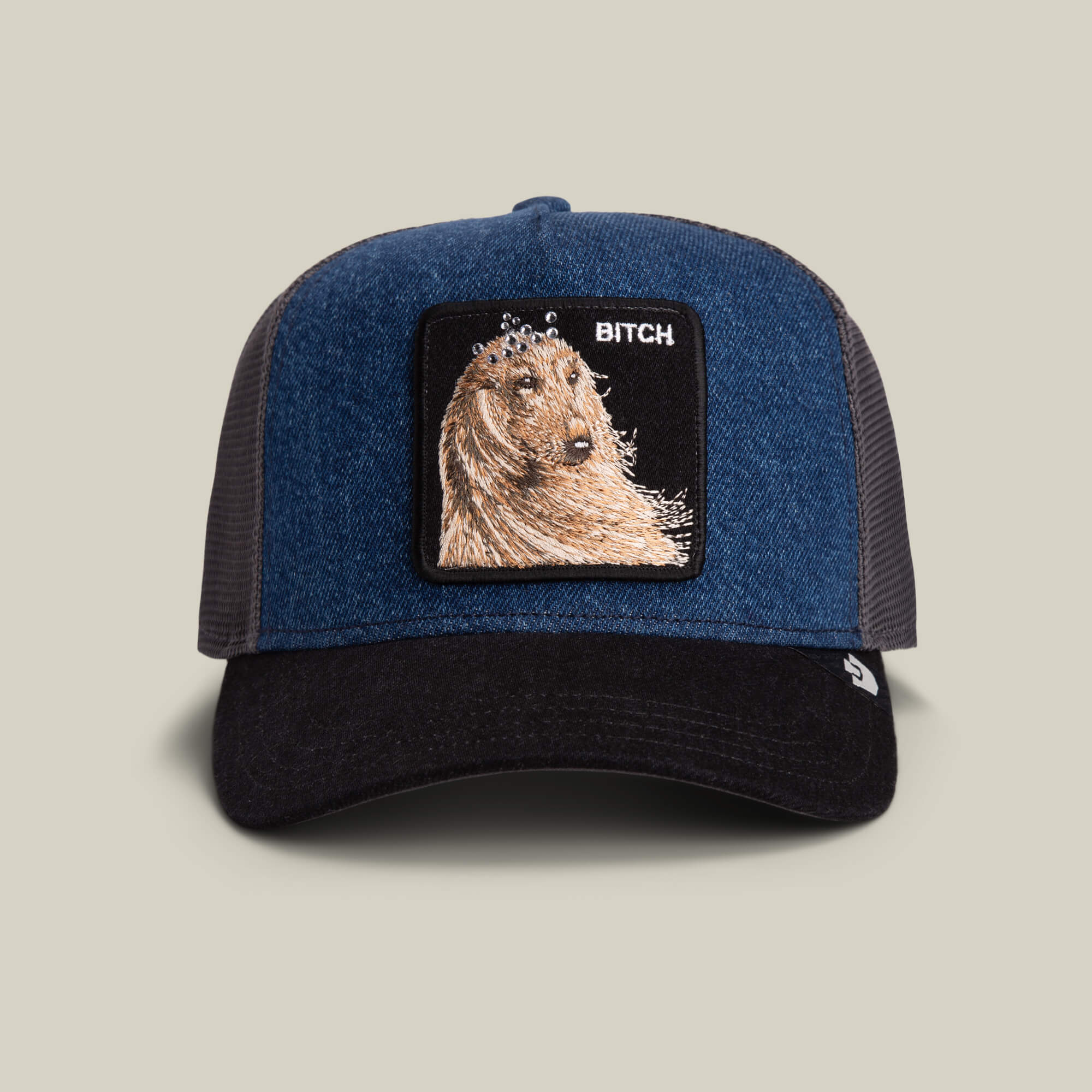 The Hound Dawg hat by Goorin Bros. features a blue denim crown, hound dog patch, and bold white "BITCH" embroidery.