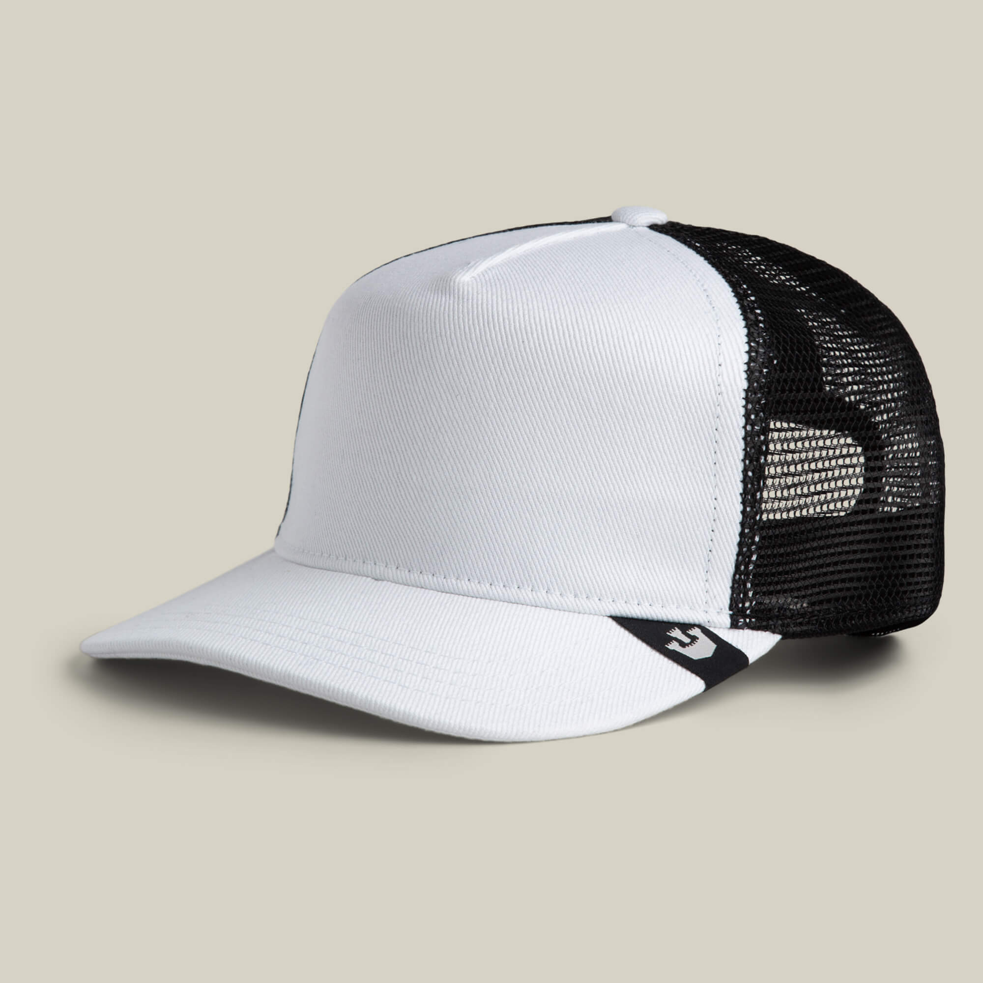 The Clean Denim Trucker by Goorin Bros. is a white and black denim trucker hat featuring a curved brim, mesh back panels, and a small black logo tag on the side, shown on a plain background.