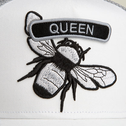 Embroidered "QUEEN" bee patch by Goorin Bros. from the Classic Rocker - Queen collection, set on white fabric—ideal for adding flair to your white or grey rocker jacket.