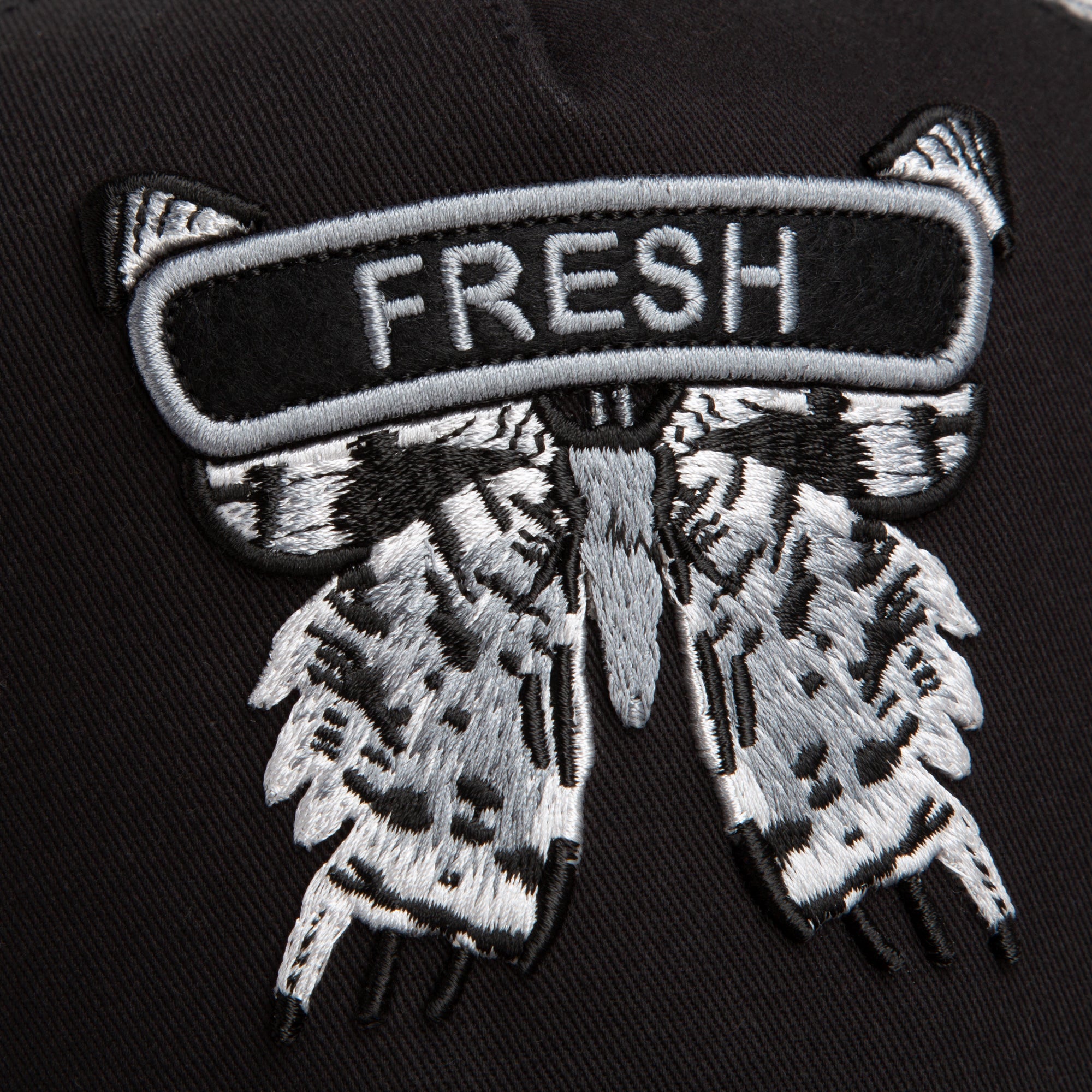 Close-up of the Goorin Bros. Classic Rocker - Fresh patch: a moth with outspread wings on black fabric, "FRESH" stitched above—great for adding edge to your night mode outfit or black mesh hat.