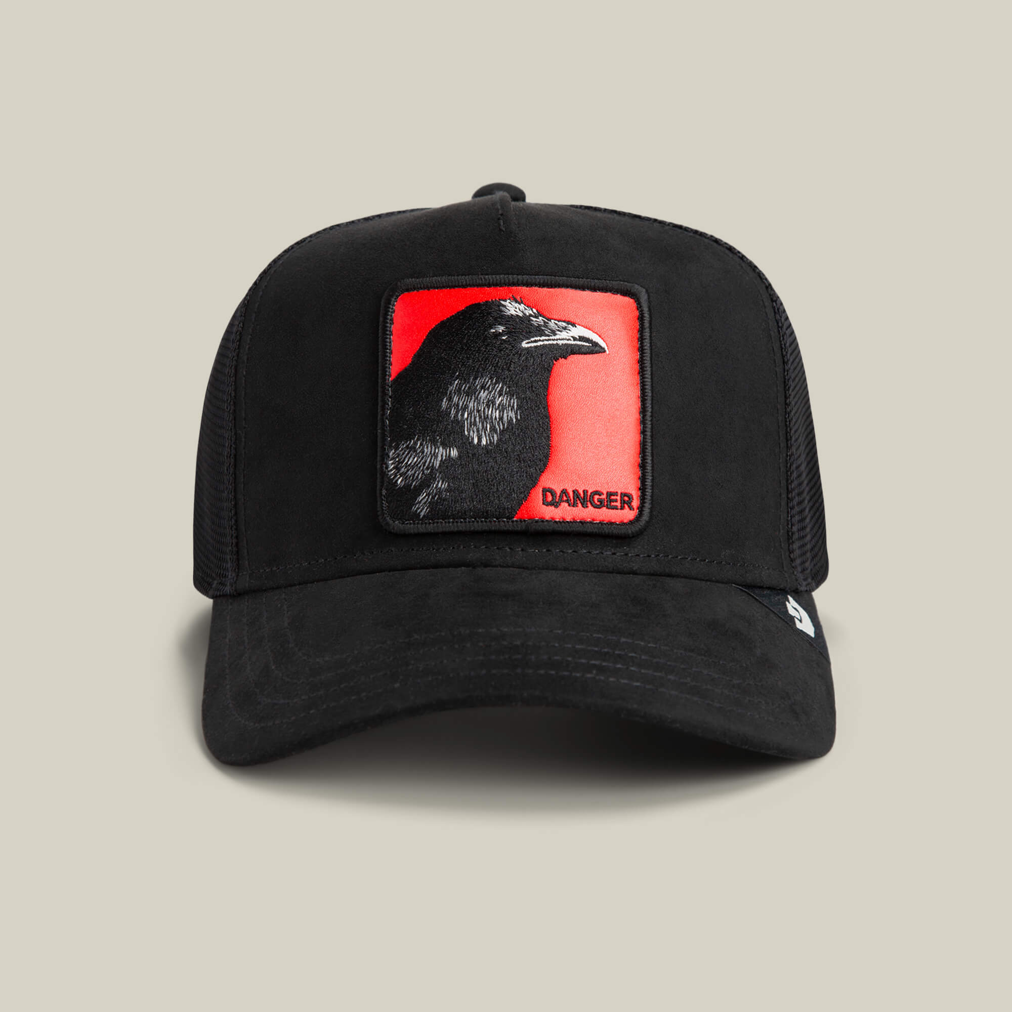 The Corvo Rosso by Goorin Bros. is a black trucker hat with a signal red patch, a sharp-eyed black bird, and "DANGER" in the corner—ideal for Corvo Rosso fans.
