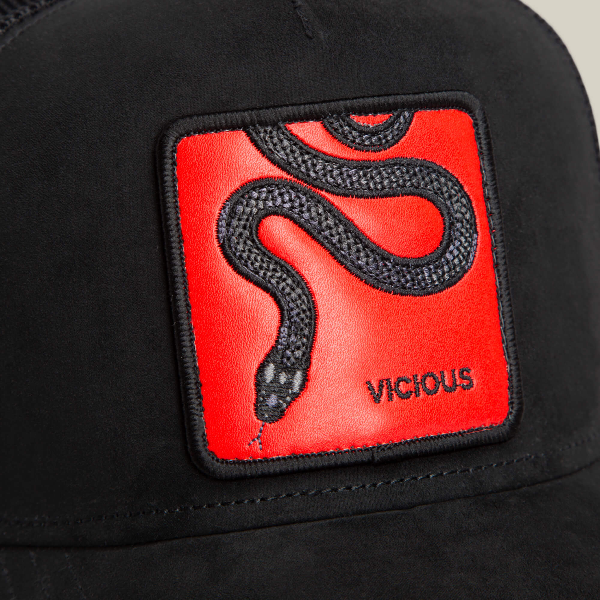 The Serpente Rosso by Goorin Bros. is a black microsuede hat with a red patch showcasing an embroidered black snake and the word VICIOUS beneath its head, symbolizing a red-hot strike.