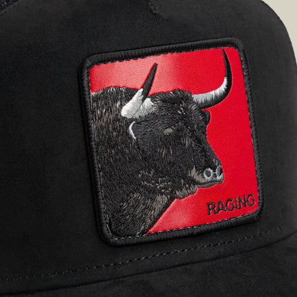 Close-up of the Goorin Bros. Toro Rosso black cap, showcasing a patch with an embroidered bull’s head on a red background and “RAGING” in the lower right, embodying the dynamic spirit of a power forward in motion.