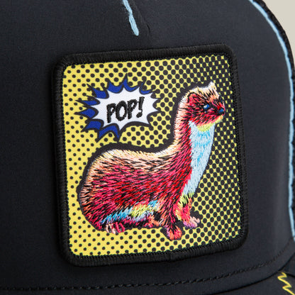 The Goorin Bros. All Around the Mulberry Bush trucker hat features an embroidered patch with a colorful weasel and a comic speech bubble reading "POP!" against a yellow dotted background for a bold, playful look.