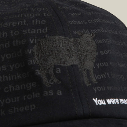 The Define Yourself - Black Sheep cap by Goorin Bros. is a low-profile papa hat featuring a subtle black sheep graphic and partially visible white text across the front.