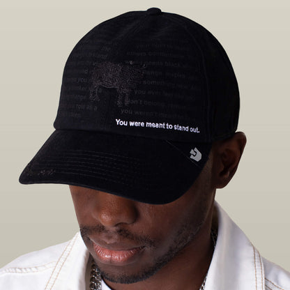 A person wears the Goorin Bros. Define Yourself - Black Sheep hat featuring "You were meant to stand out" text, a subtle animal graphic, and faded words.