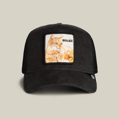 The Goorin Bros. Terry Cloth Cat trucker hat in VOID features a square patch with an embroidered orange cat and "BOUJEE" on the front, blending luxe loungewear inspiration with plush comfort for a stylish vibe.