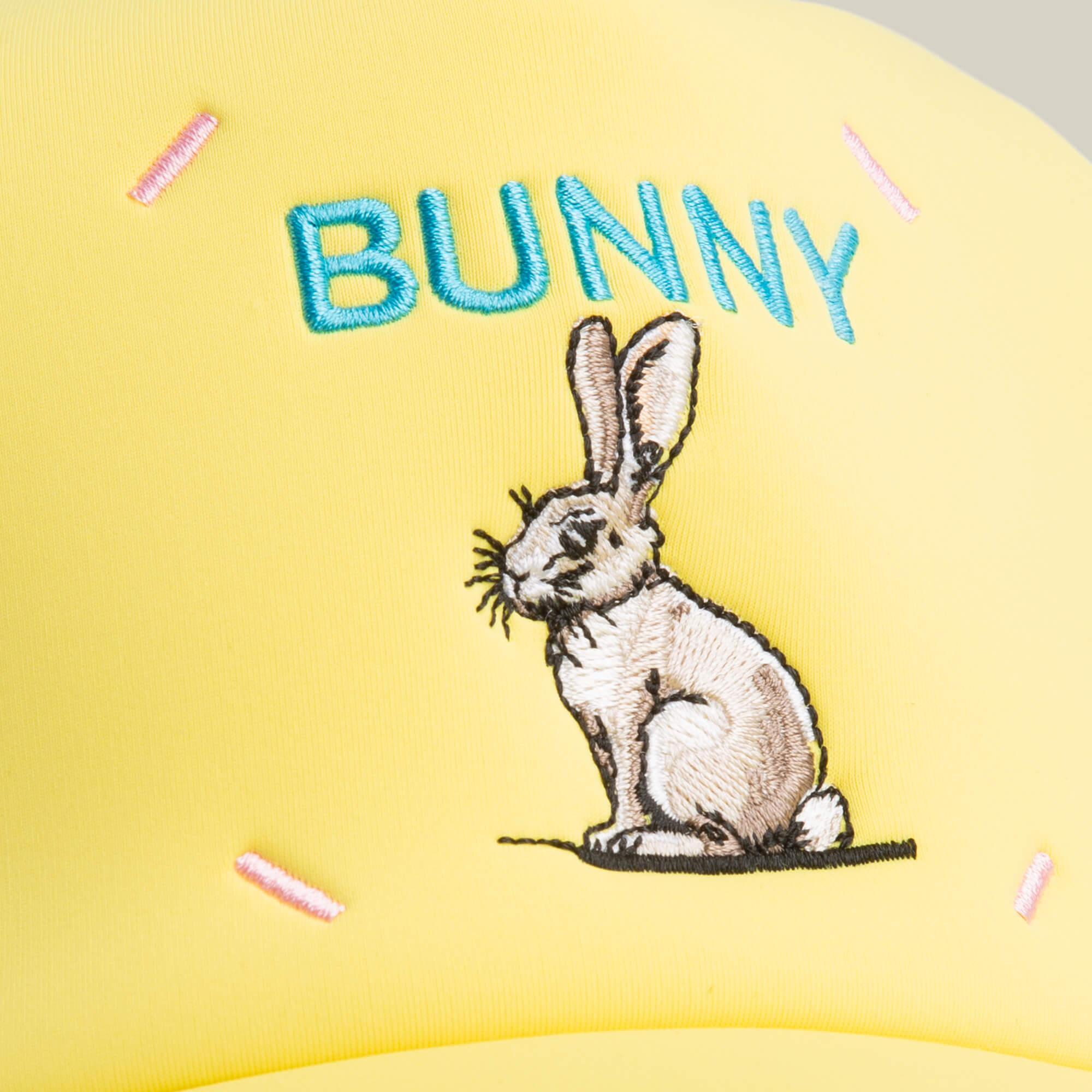 The Neo Farm - Bunny Rabbit cap by Goorin Bros. features a sitting bunny and "BUNNY" in blue with pink stitch accents—perfect for everyday style.