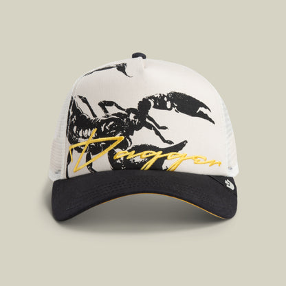 The Goorin Bros. Outside the Lines Scorpion cap in DUST / VOID features a mesh back, bold scorpion patch, and yellow "Duggan" script above the brim.