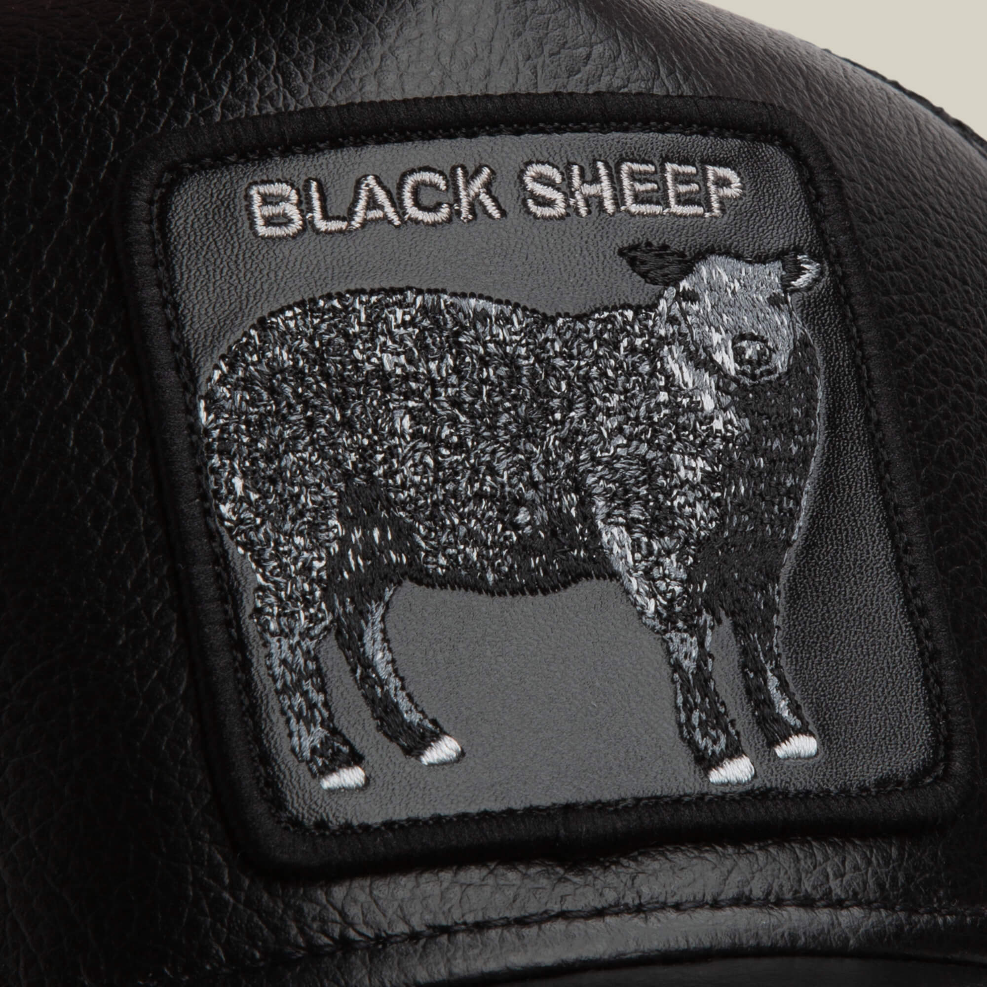 The Goorin Bros. Faux Leather Sheep patch is crafted from black faux leather and features an embroidered black sheep with "BLACK SHEEP" stitched above.