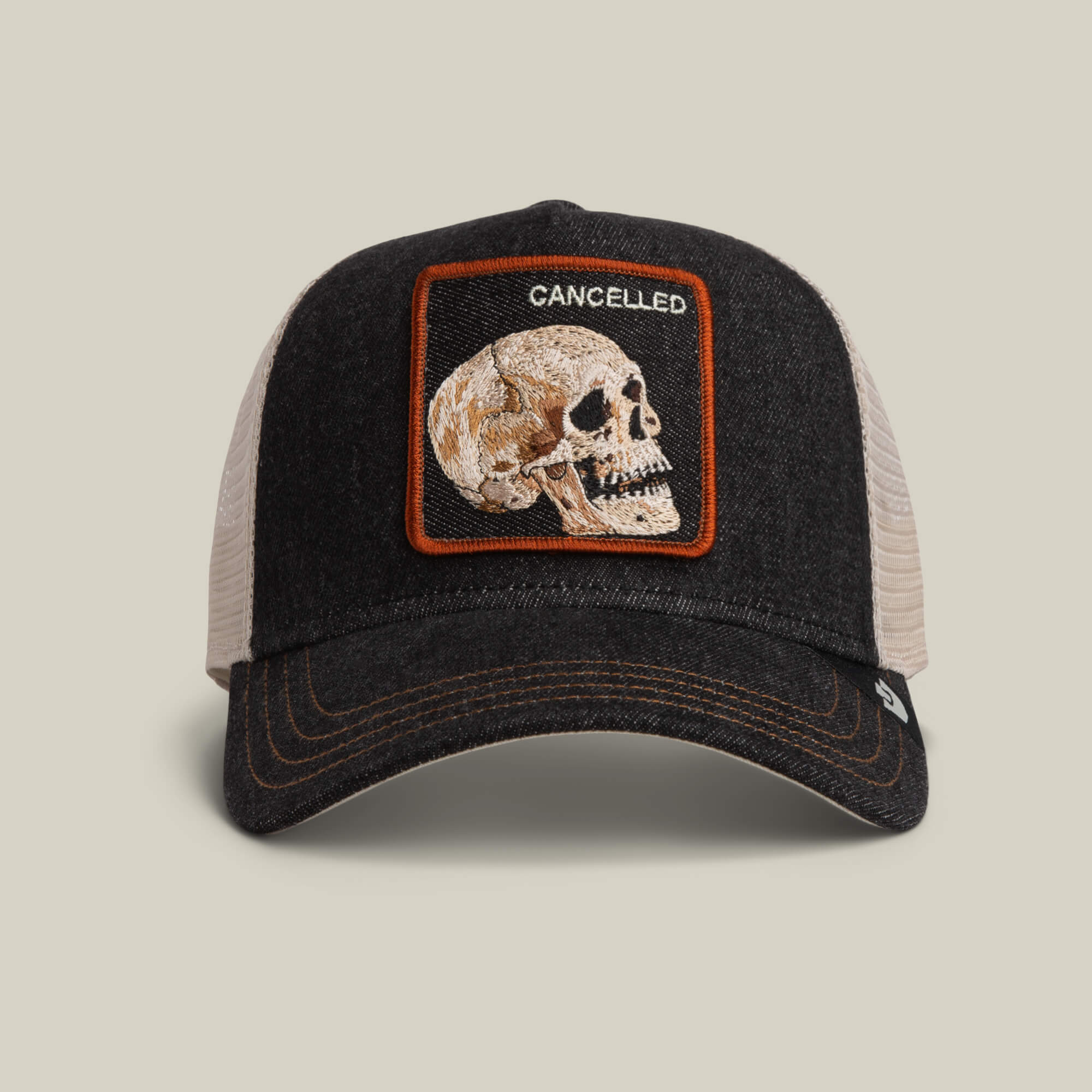 The Denim Skull by Goorin Bros. is a two-tone trucker hat in dark denim with a bold skull patch and "CANCELLED" above it.