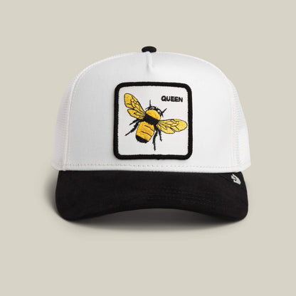 The Suede Bee by Goorin Bros. is a DUST/VOID trucker hat with a Queen patch, embroidered yellow bee, and sleek black microsuede brim for extra style.