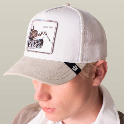 A person wears the Goorin Bros. Suede Rattlesnake hat, featuring a beige and white design, suede brim, and a front patch with a rattlesnake and the word OUTLAW.
